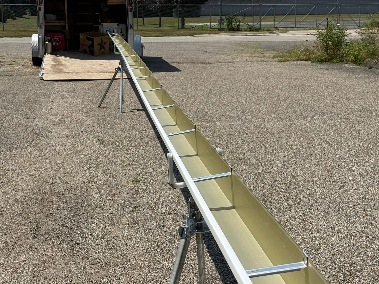 A custom seamless gutter formed on-site, ready for installation