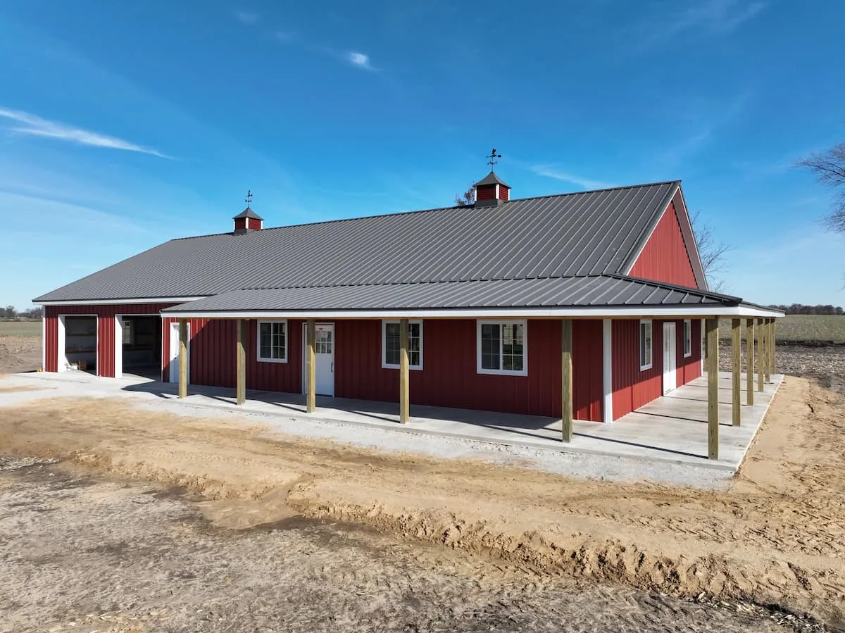 Red pole barn with a charcoal metal roof